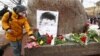 SPB, RUSSIA - FEBRUARY 27, 2021: People lay flowers at the Solovetsky Stone to mark the 6th anniversary of Boris Nemtsov's assassination